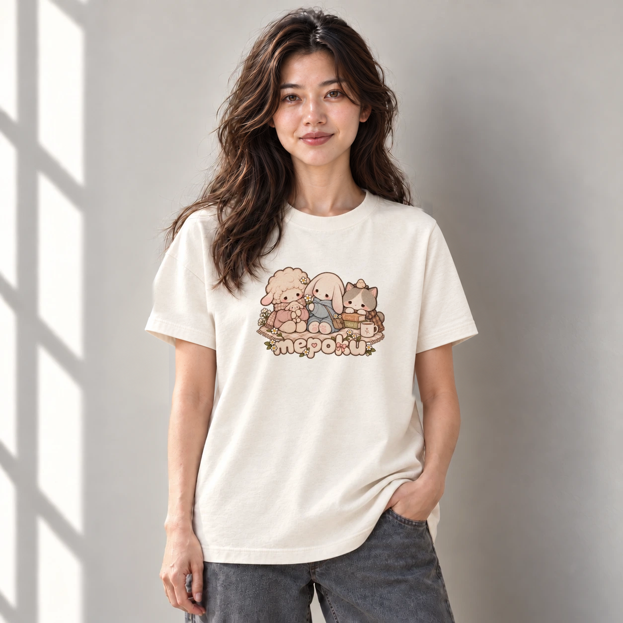 Model wearing a cream tee with Mello, Pomu, Kumo and the Mepoku lettering